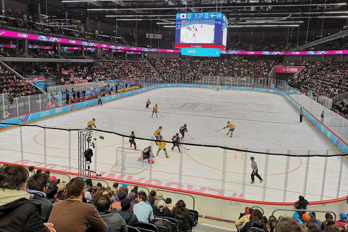 A girls' ice hockey final seen from high in the stands