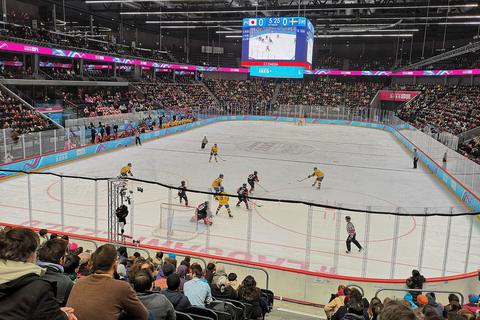 A girls' ice hockey final seen from high in the stands
