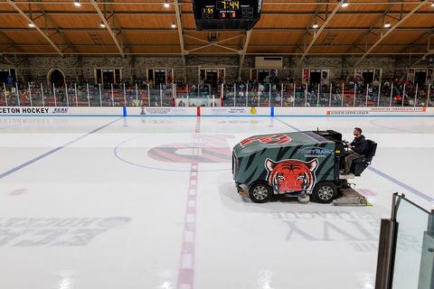 A resurfacer crossing centre ice in an empty college rink